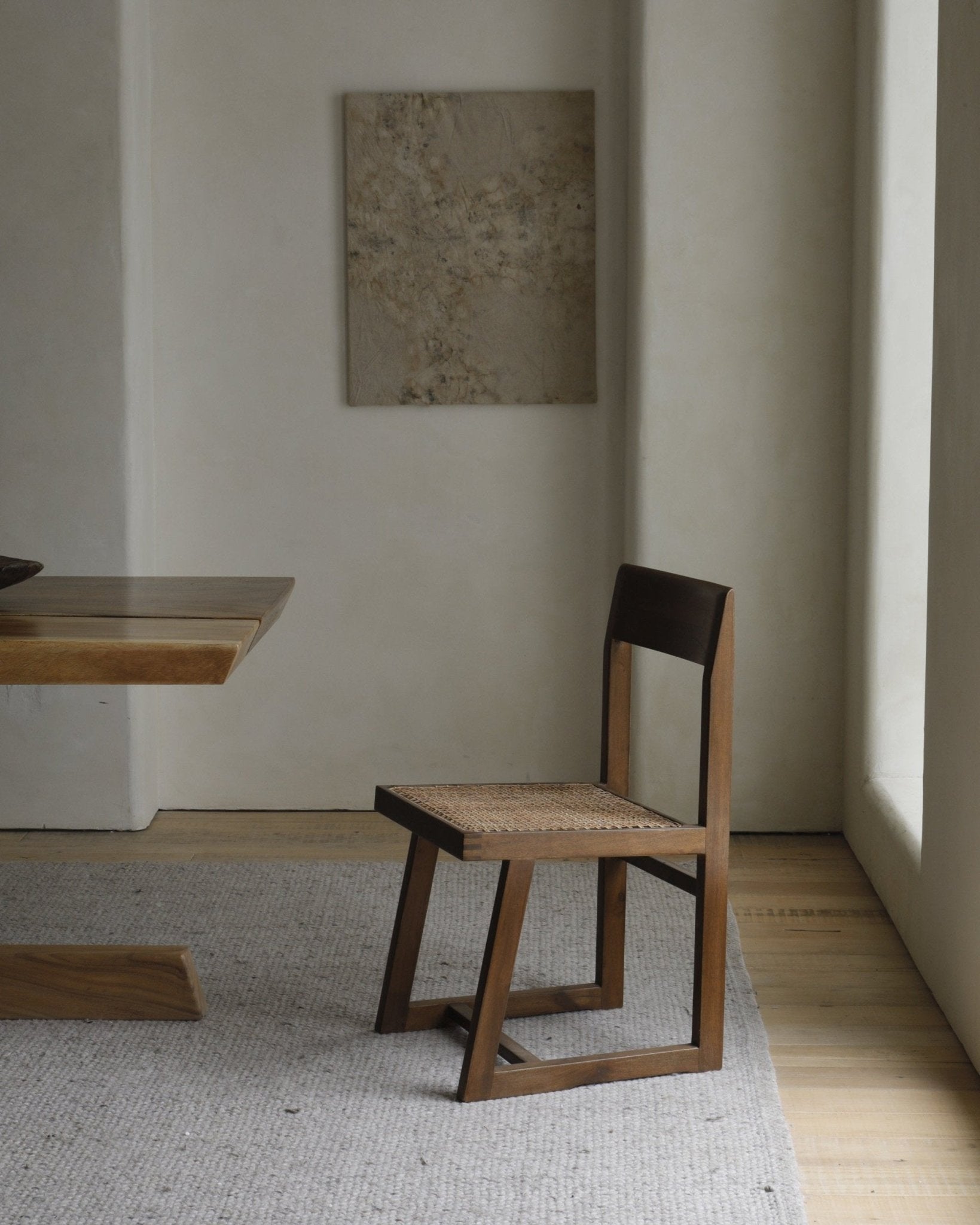 Chandigarh Box Chair in mid-century modern design with woven seat and wooden frame.