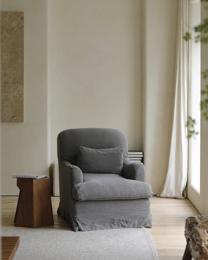 Soft gray slipcover armchair with plush cushion in a serene living area