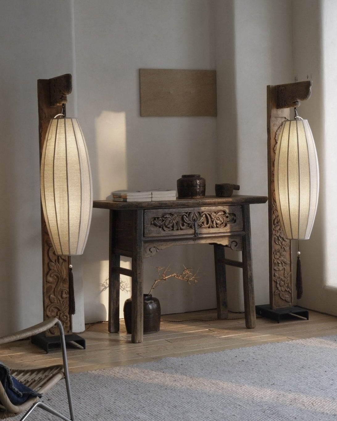 Chinese floor lamp with fabric shade, wooden frame, and detailed carvings. Interior home decor with oriental style.