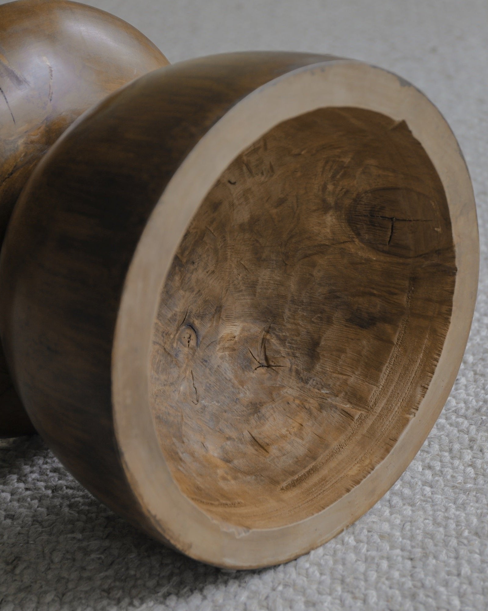Close-up of a Sandglass Table made of Samanea saman wood, showing natural wood grain and texture.
