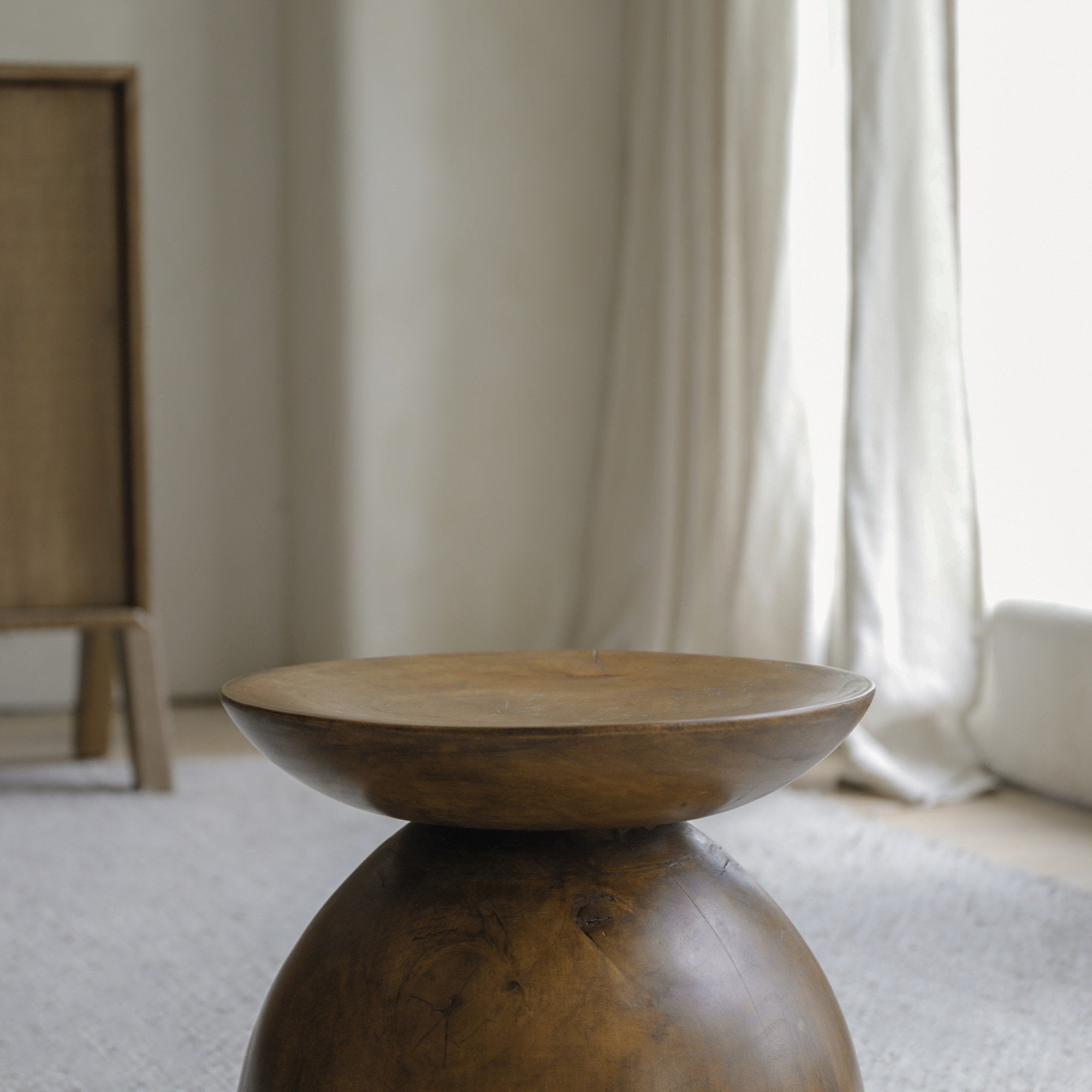 Sandglass table made from Samanea saman wood, hourglass design, minimalist living room decor.